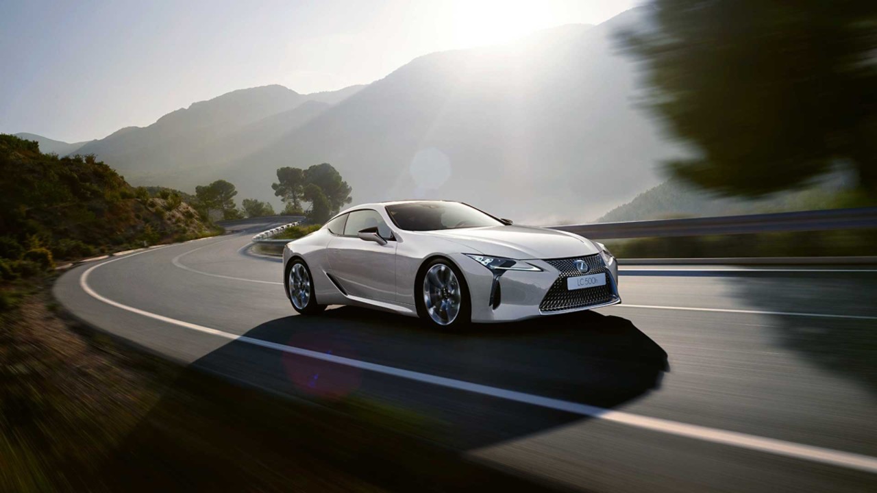 A Lexus LC 500h driving on a mountainous road 