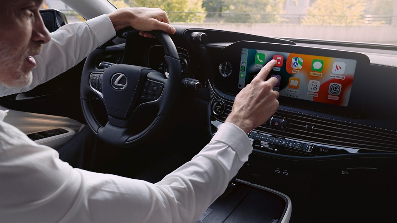 A man interacting with the Lexus LS multimedia display 